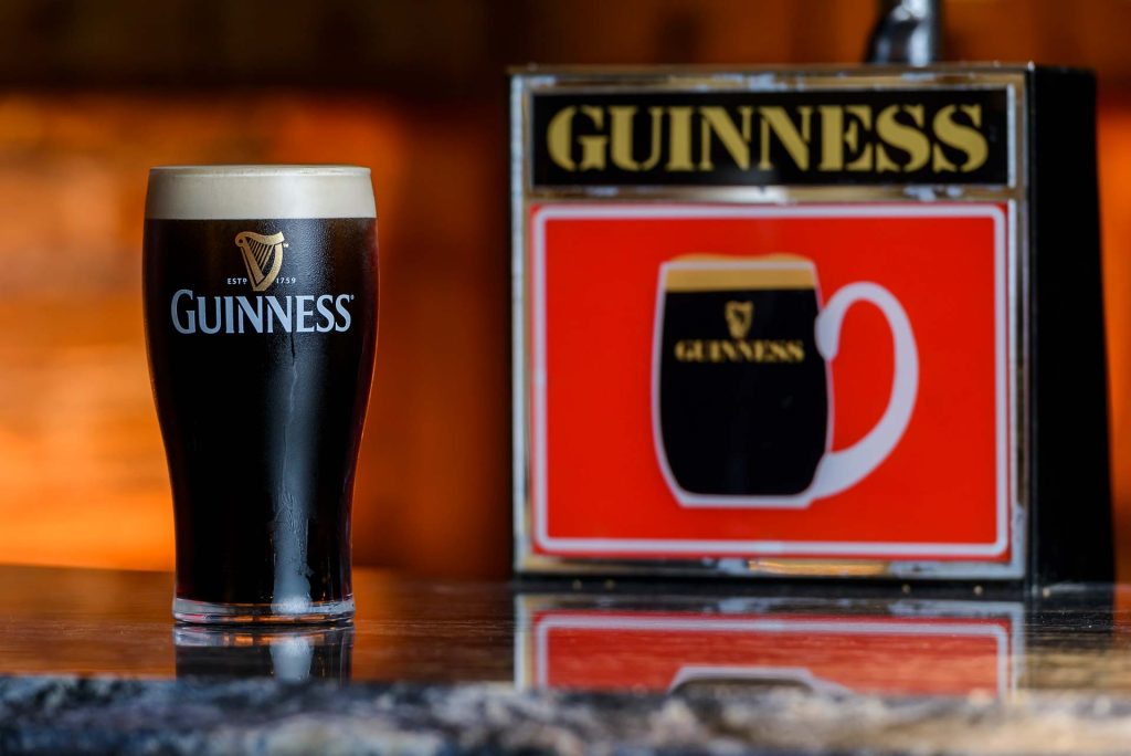 Pint of Guinness next to a retro tap