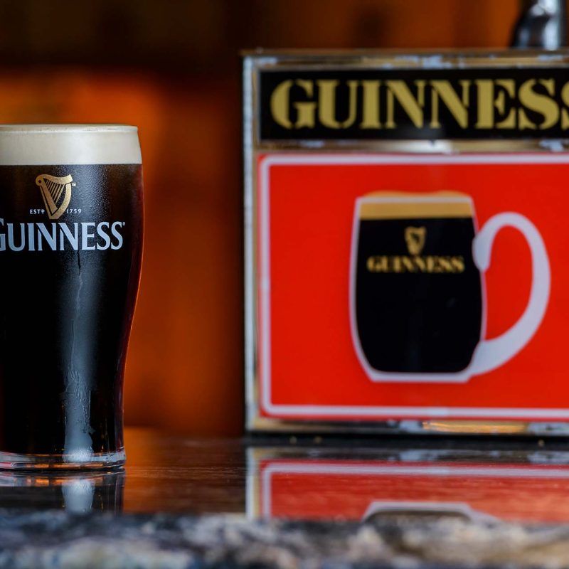Pint of Guinness next to a retro tap