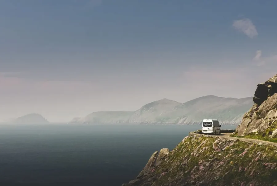 Rabbies Minibus on Cliff Road with Sea on Left